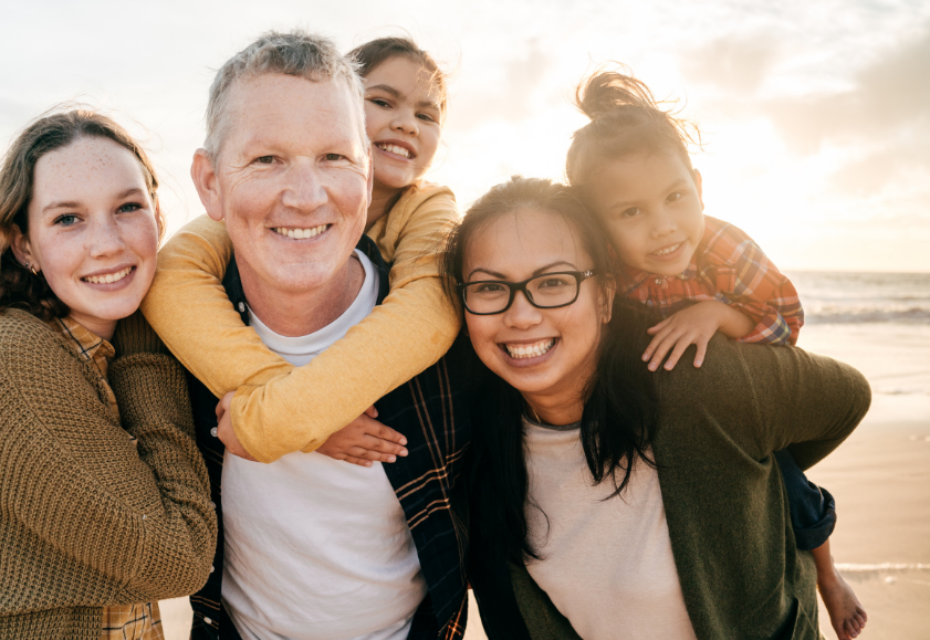Smiling family of two parents and three children