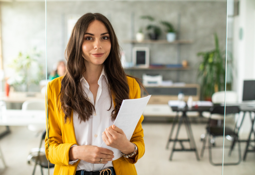 Workplace service adviser holding documents ready to give HR support in an office