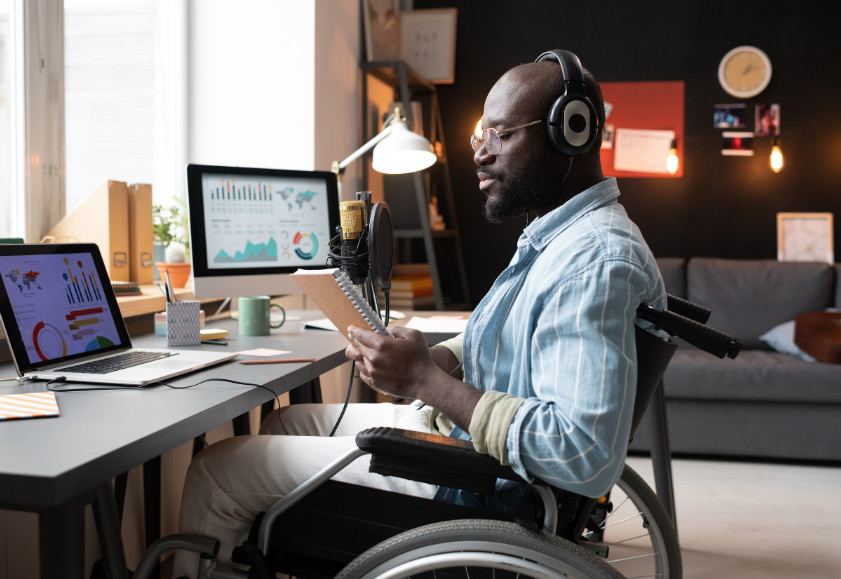 Man in a wheelchair working at his computer